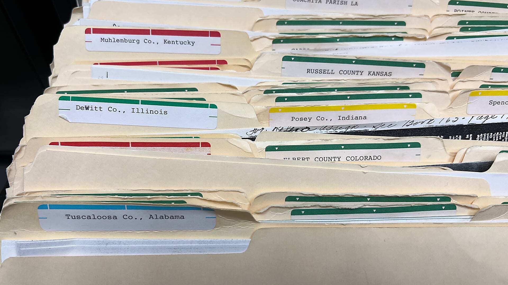 Paper county and mineral records stored in file cabinets before document scanning