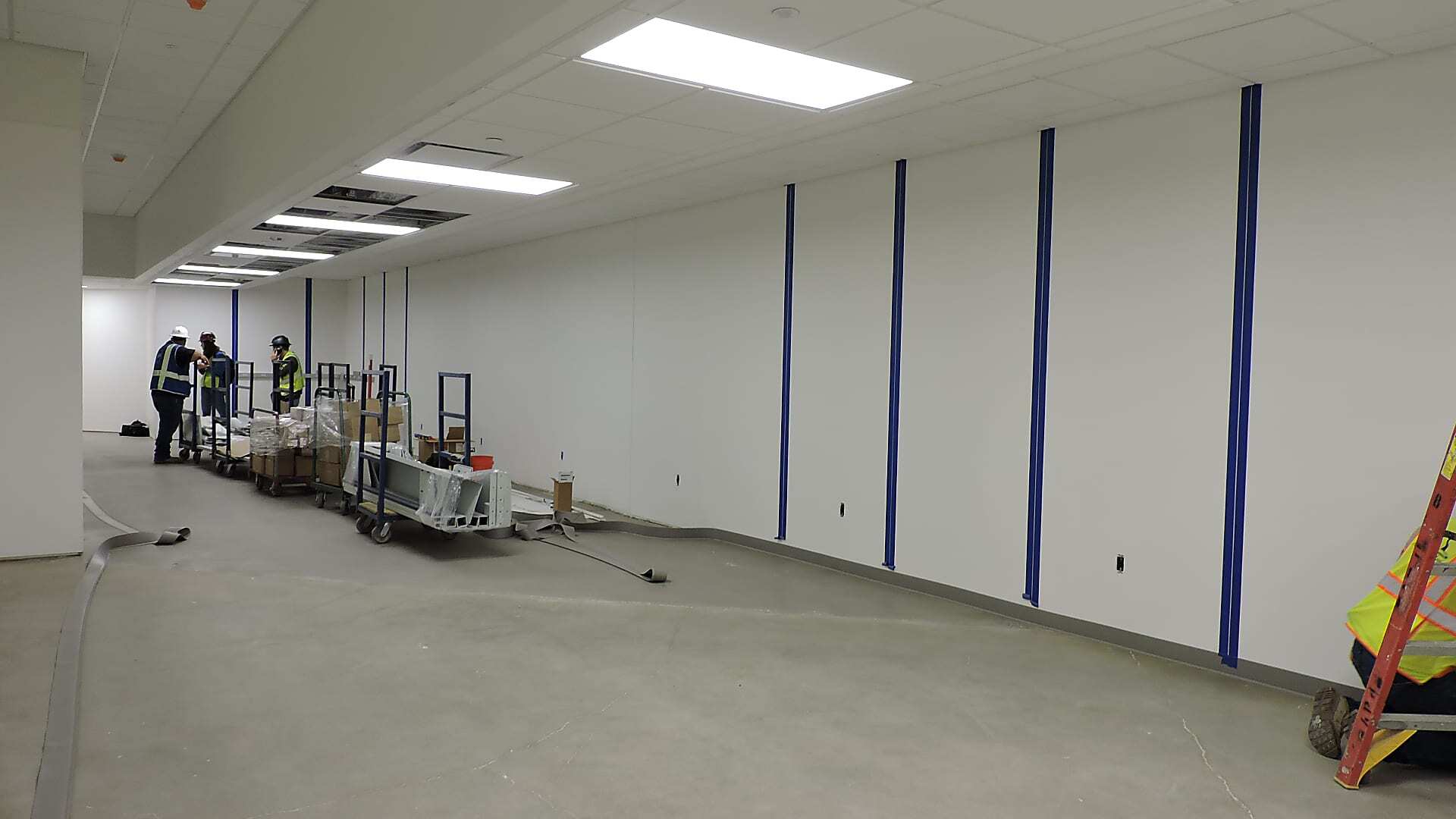 Floor-staged hospital beds occupying storage space before the BedStacker project