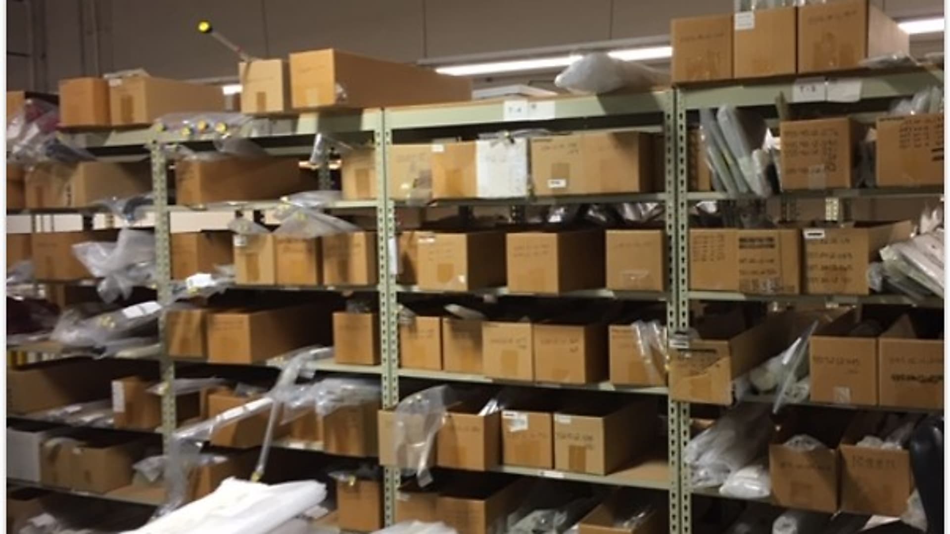 Warehouse mezzanine shelving before Kardex Vertical Lift Module installation for a business aircraft manufacturer in the Denver metro area