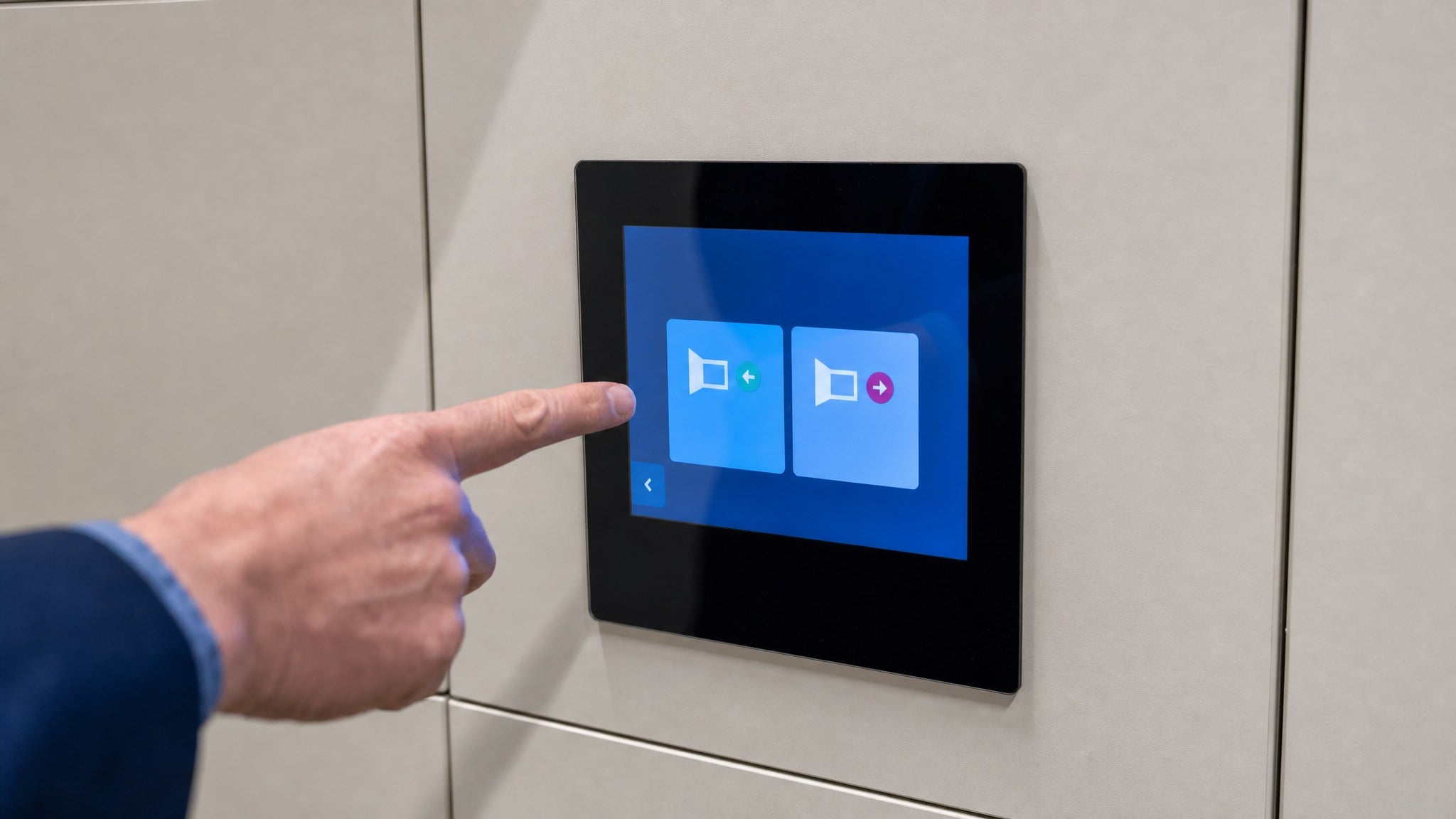 Person's finger touching a touchscreen panel on a light-colored locker bank.