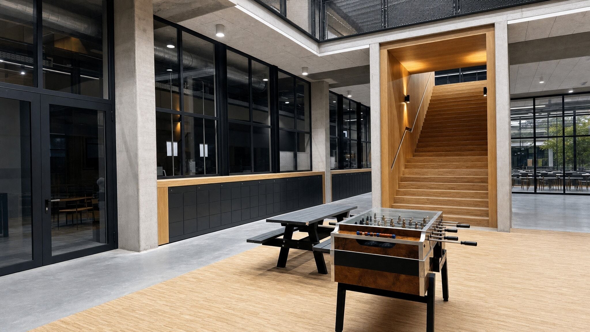 Long bank of dark lockers against a glass wall in a modern open room.