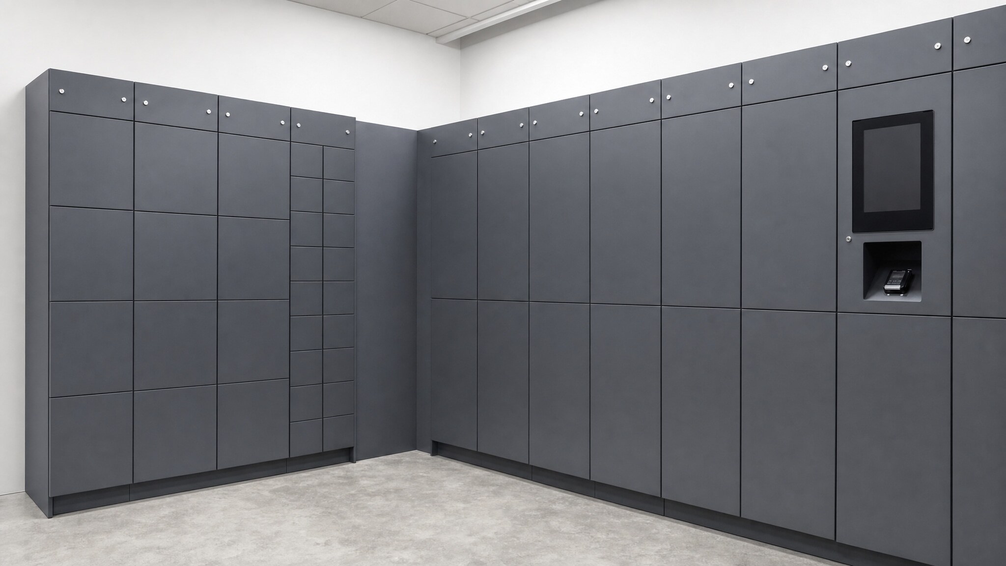 Gray locker wall with integrated display and access panel in a corner room.