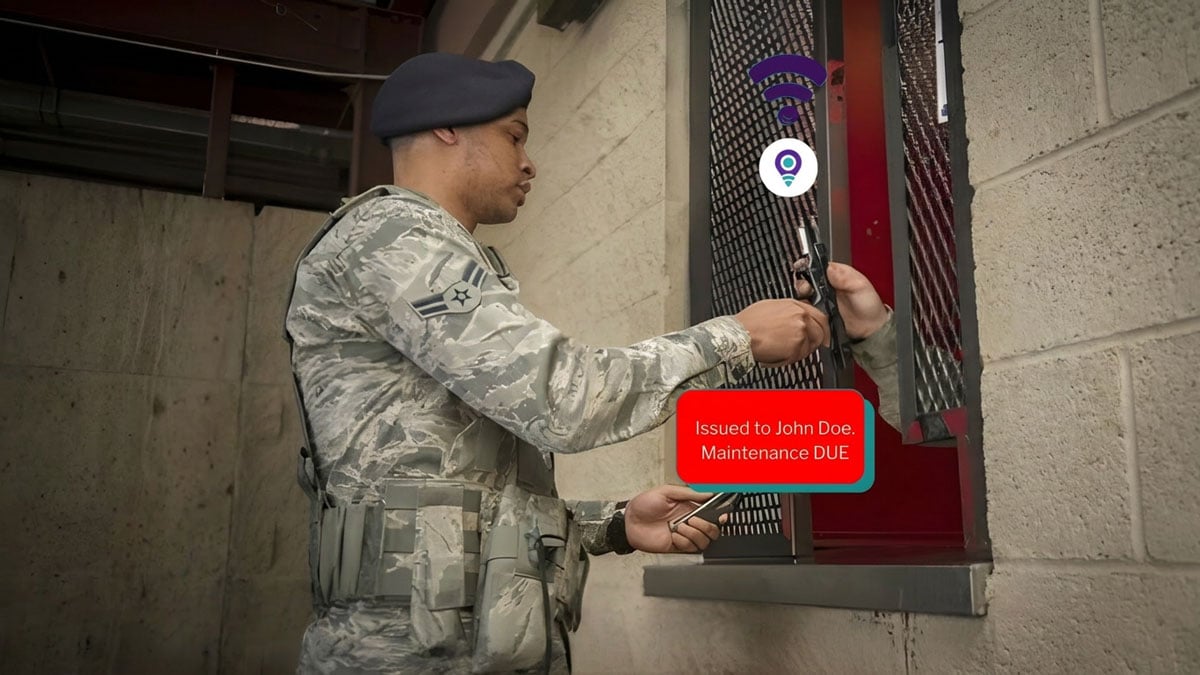 Hand holding a firearm with GPS GSM weapon tracking and alert device attached